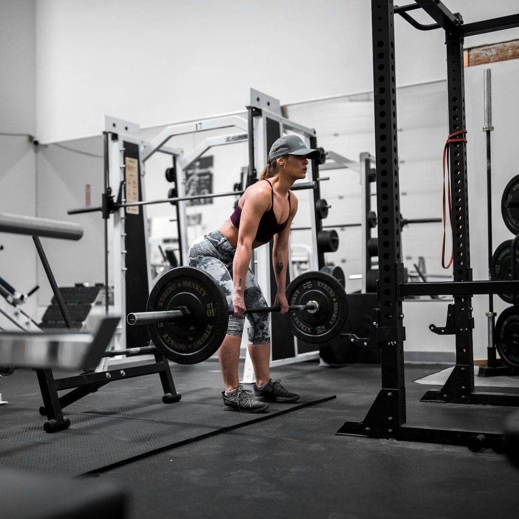 man in orange tank top and black shorts doing exercise